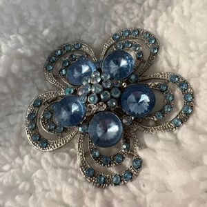 Blue flower brooch. Measures a little more than 2”